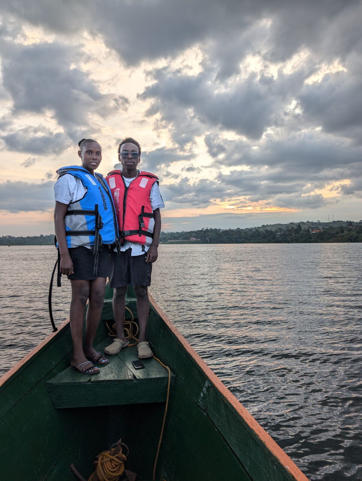 Standing on the bow of a boat at sunset